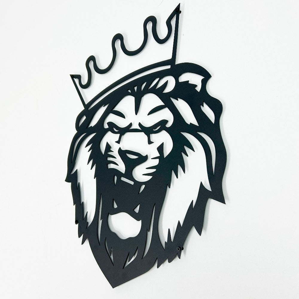 Close-up view of a black metal lion wall art with a crown, showcasing detailed craftsmanship and a bold design on a white background.