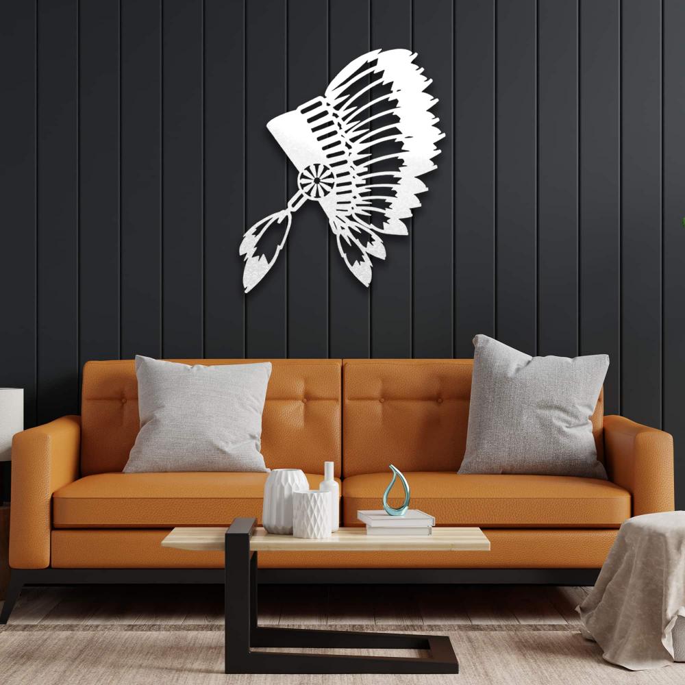 White metal wall art of an Indian chief's feathered headdress displayed on a black-paneled wall above a burnt-orange sofa for a striking color contrast.