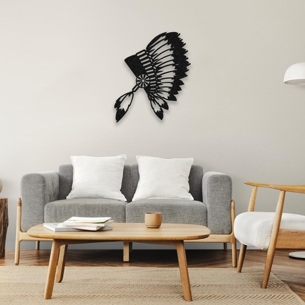 Black metal wall art of an Indian chief's feathered headdress hanging above a simple grey couch with wooden furniture accents in a cozy and inviting living room.