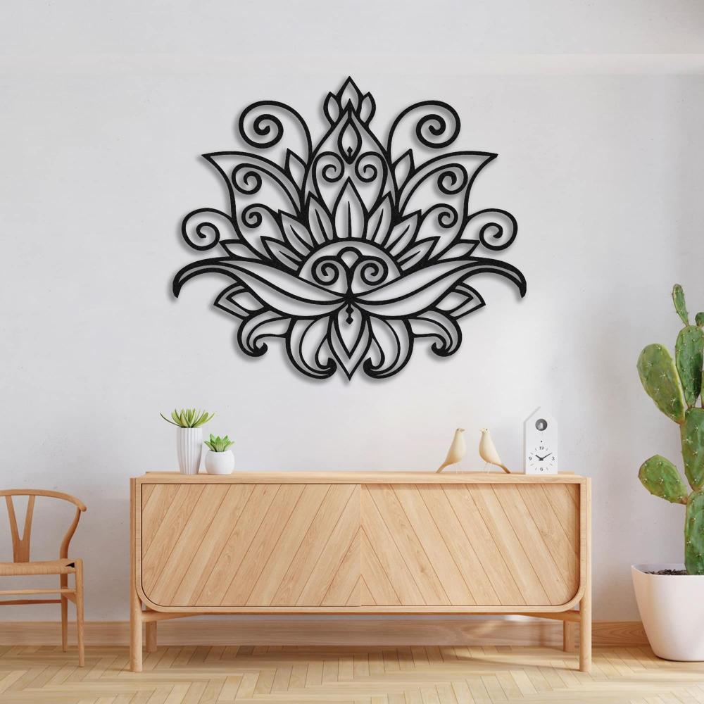 Mandala lotus metal wall art featuring intricate black floral patterns, mounted on a white wall above a light wooden console table, complemented by minimalist decor and a potted cactus.