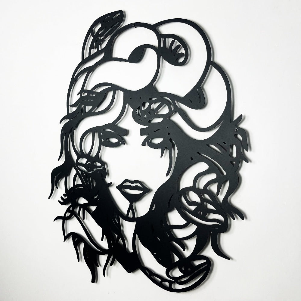 Intricate 3D metal wall art of Medusa with flowing hair and snake details, showcasing bold black lines on a clean white background.