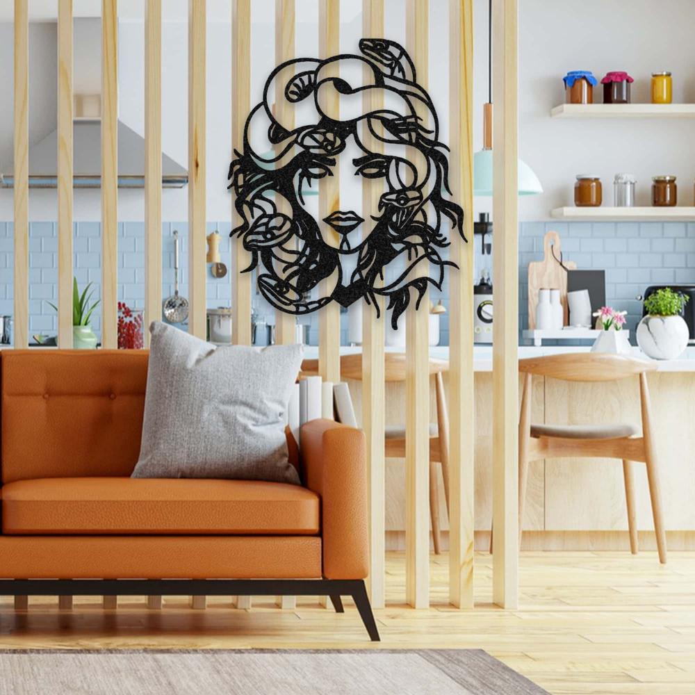 Stylish black Medusa metal wall art displayed on a vertical wooden slat wall divider, adding a modern and artistic touch to an open-plan kitchen and living area with a cozy orange couch.