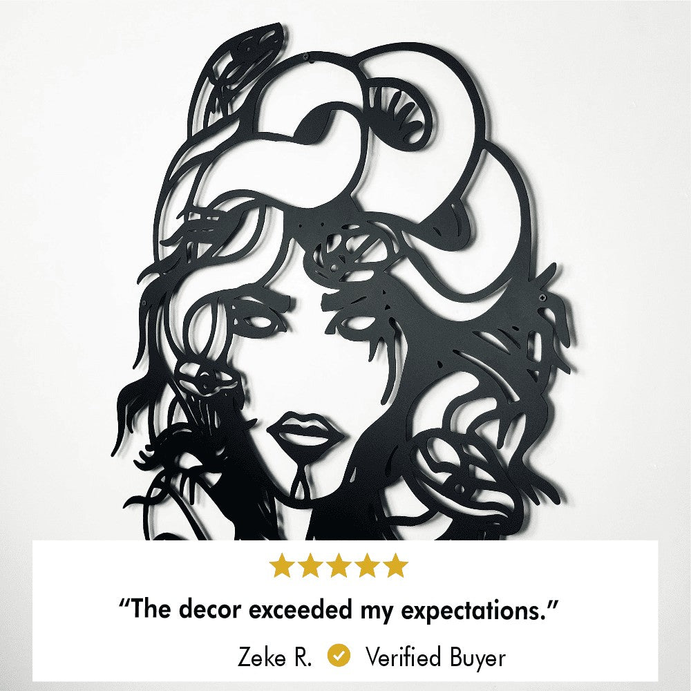 Close-up of Medusa metal wall art showing detailed snake and face features on a white wall, accompanied by a 5-star customer review stating, "The decor exceeded my expectations." – Zeke R., Verified Buyer.