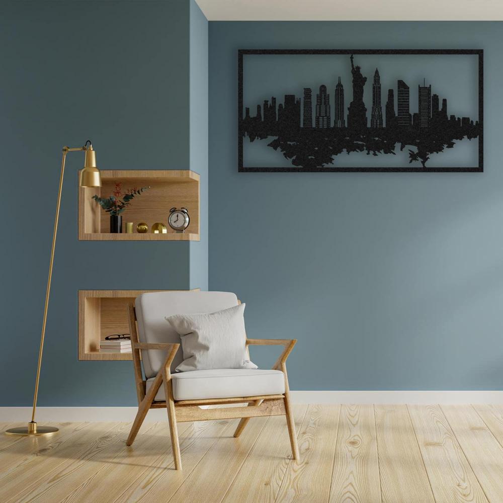 Elegant living room interior with a wooden armchair, soft white cushion, and a tall gold floor lamp. The wall features a black New York City skyline metal wall art mounted on a teal-painted background, creating a modern and sophisticated atmosphere.