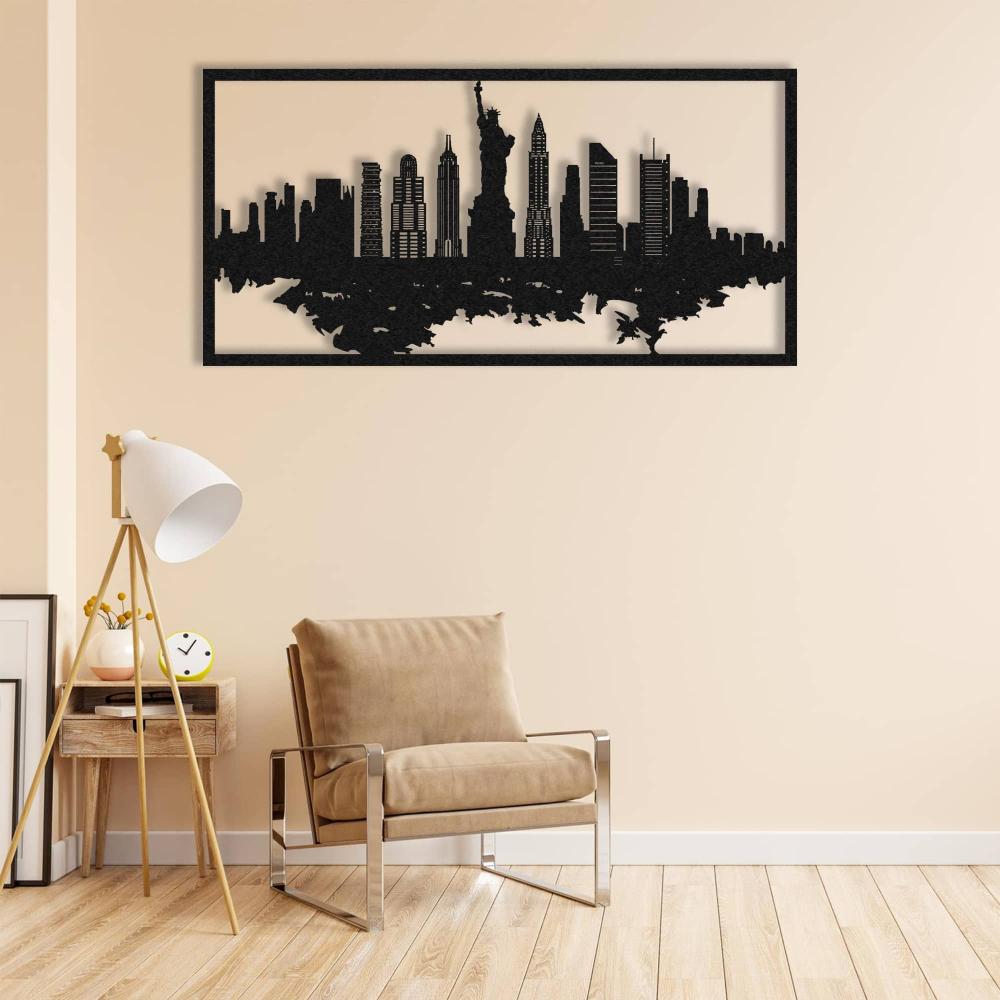 Minimalistic living room featuring a beige upholstered chair with a sleek metal frame, a small wooden side table, and a modern tripod floor lamp with a white shade. The wall displays a black New York City skyline metal wall art, adding a striking focal point to the neutral decor.