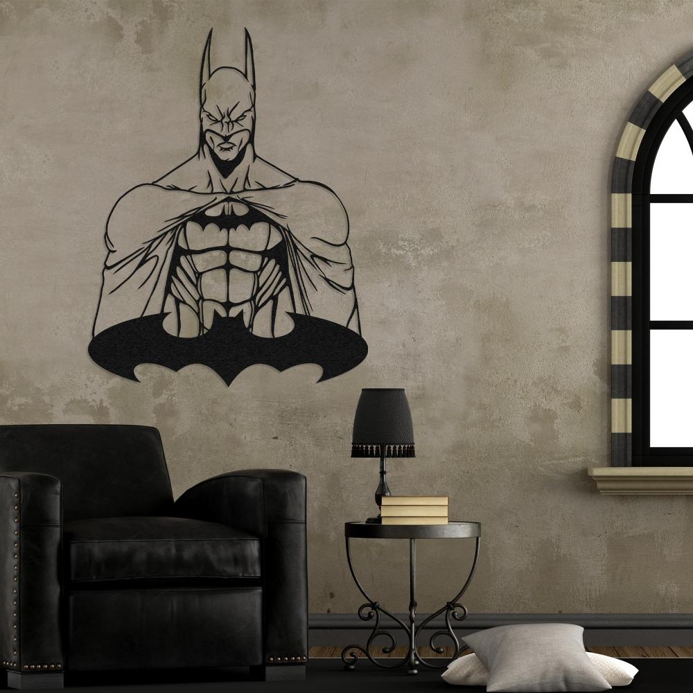 Batman metal wall art displayed on a rustic textured wall in a vintage-themed living room, featuring a black leather armchair, an elegant round side table with a black fringed lamp and books, and an arched window with striped trim.