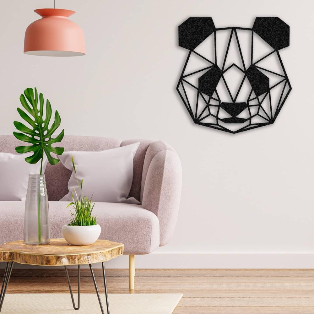Black geometric panda wall art mounted on a white wall, placed above a soft pink sofa with white cushions, complemented by a natural wooden coffee table holding a vase with greenery and a small plant, under a modern pink pendant light.