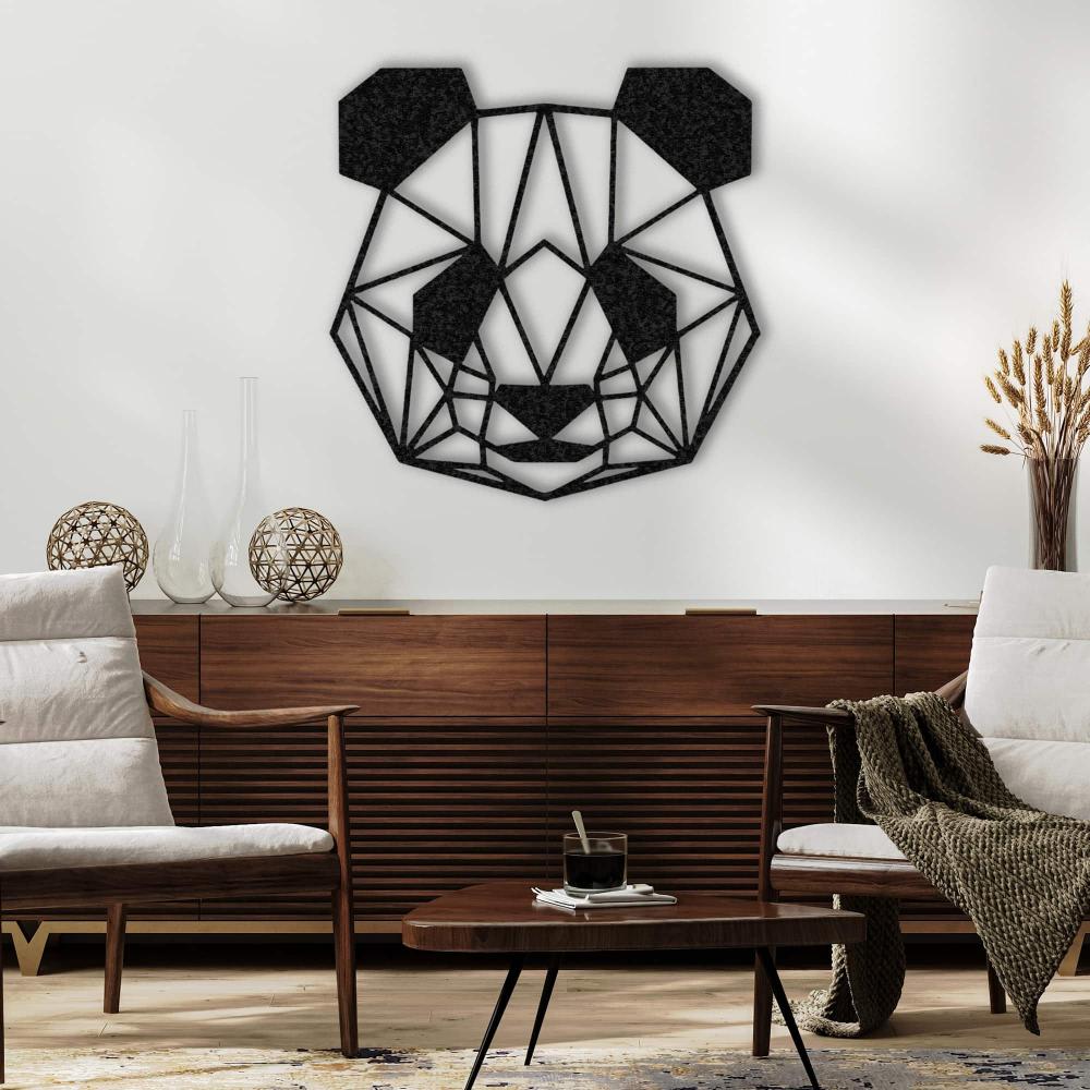 Black geometric panda wall art displayed on a white wall above a modern wooden sideboard, flanked by two cozy armchairs with neutral cushions, a textured throw blanket, decorative orbs, and vases, complemented by a sleek coffee table with a glass of coffee and a book in a contemporary living room.