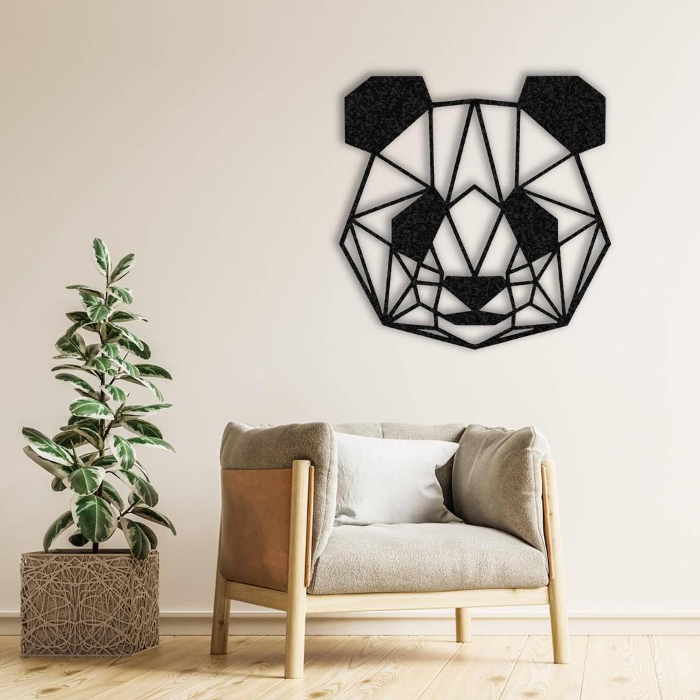 Black geometric panda wall art displayed on a neutral wall, complemented by a modern beige armchair with a cushion and a potted plant, creating a cozy and minimalist decor vibe.