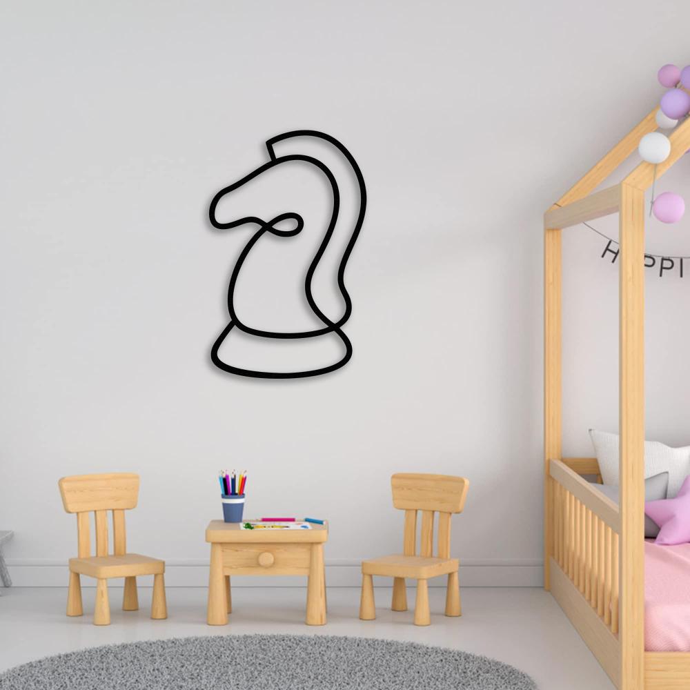 A minimalist black line art of a chess knight mounted on a nursery wall, surrounded by small wooden chairs and a table with art supplies.