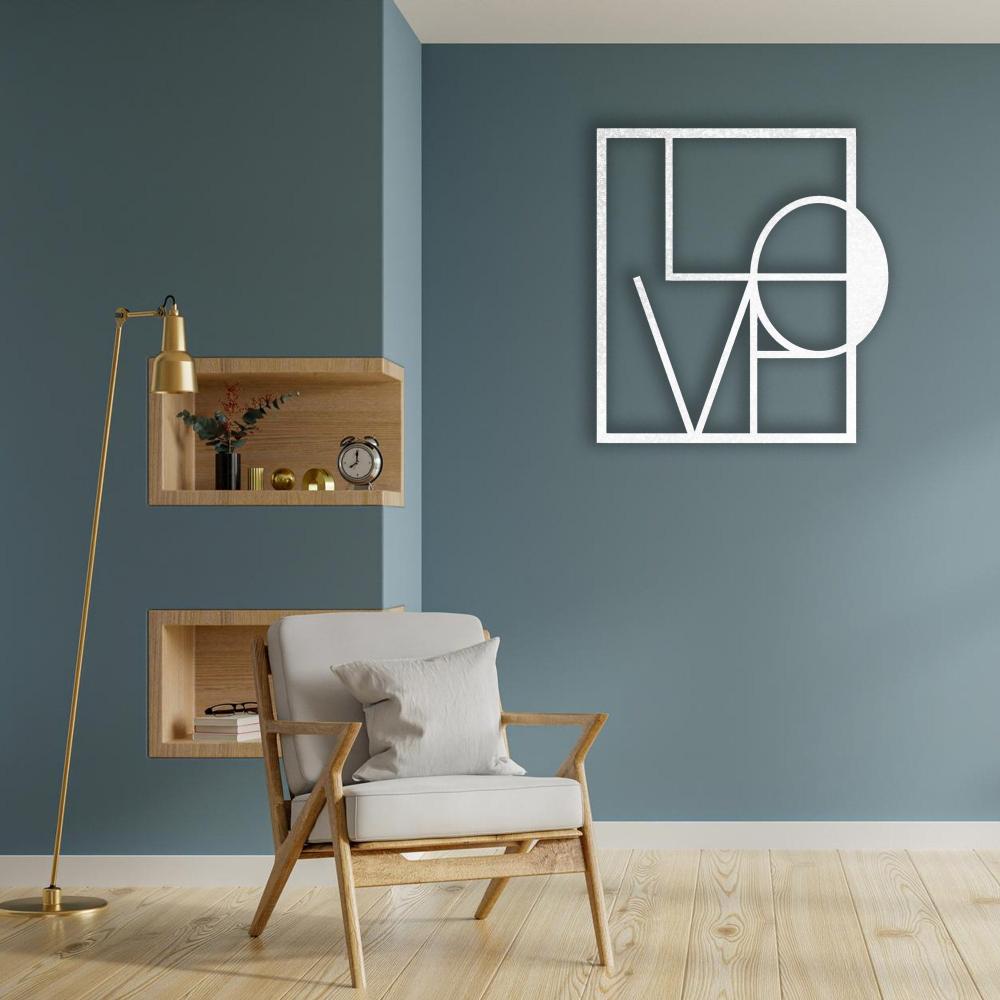 A modern room with white metal "LOVE" wall art in a geometric design, mounted on a blue wall with minimalistic decor including a wooden shelf and gold accents.
