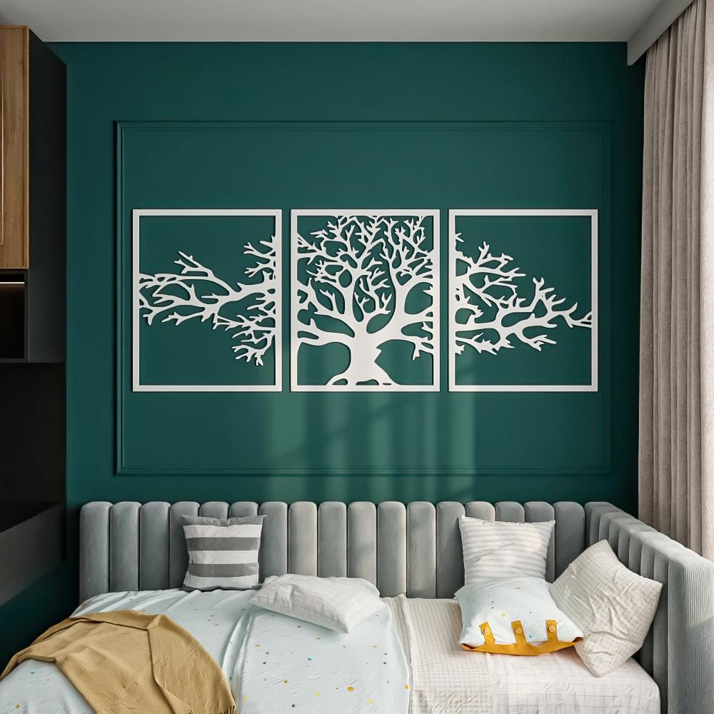 A stylish bedroom features a triptych metal wall art of a tree with bare branches in white, set against a rich green wall. The metal frames create a bold visual impact.