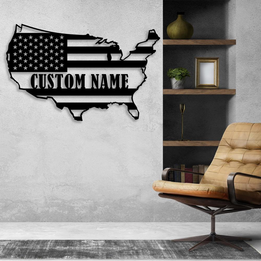 Black metal USA map wall art with customizable text mounted on a concrete wall, paired with a leather chair and built-in wooden shelves for an industrial aesthetic.