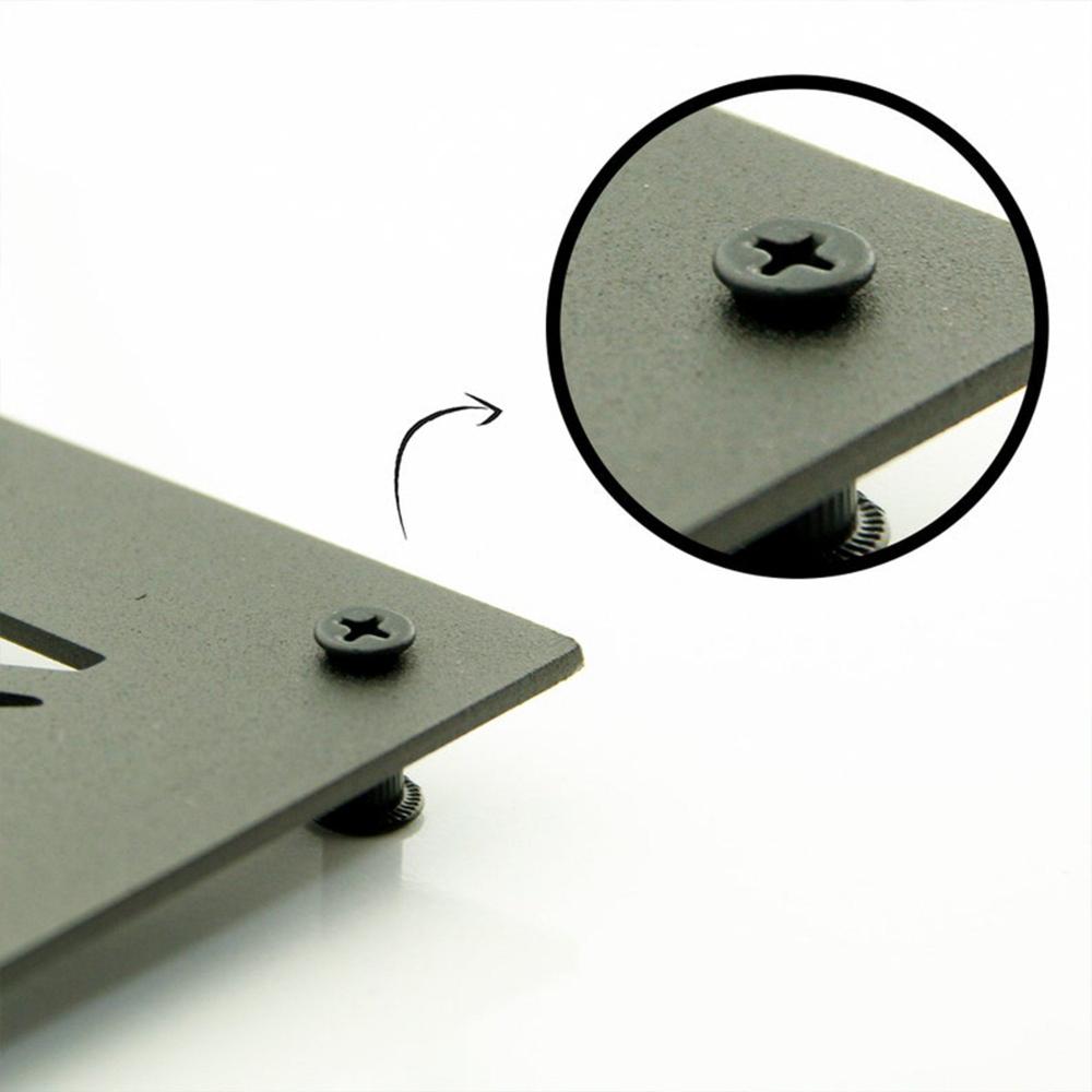 Close-up view of a metal wall art spacer, showing the textured black finish and the precise screw fit for easy mounting.