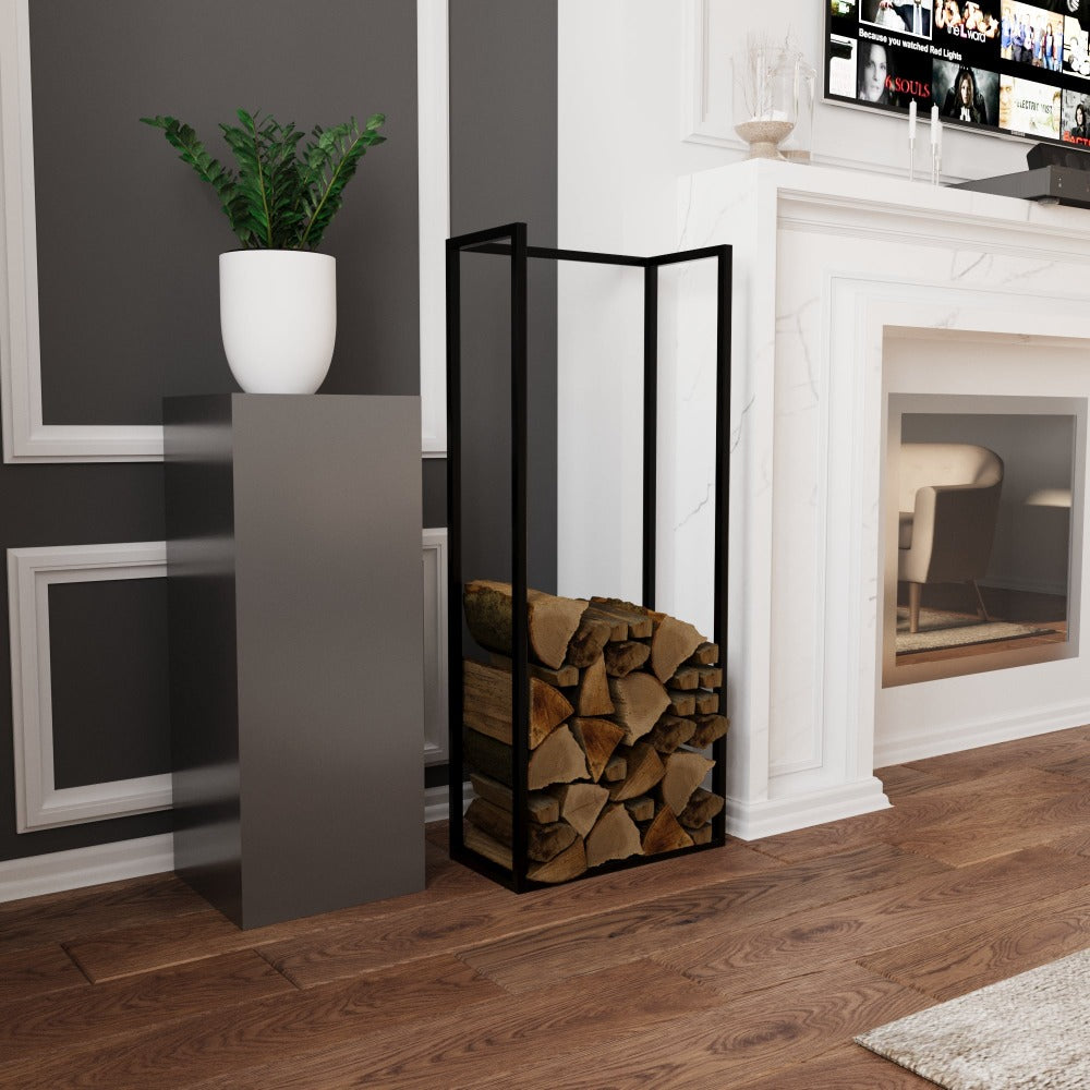 Minimalist black metal wood holder placed next to a white planter on a modern pedestal, in front of a stylish fireplace in a living room with wooden floors