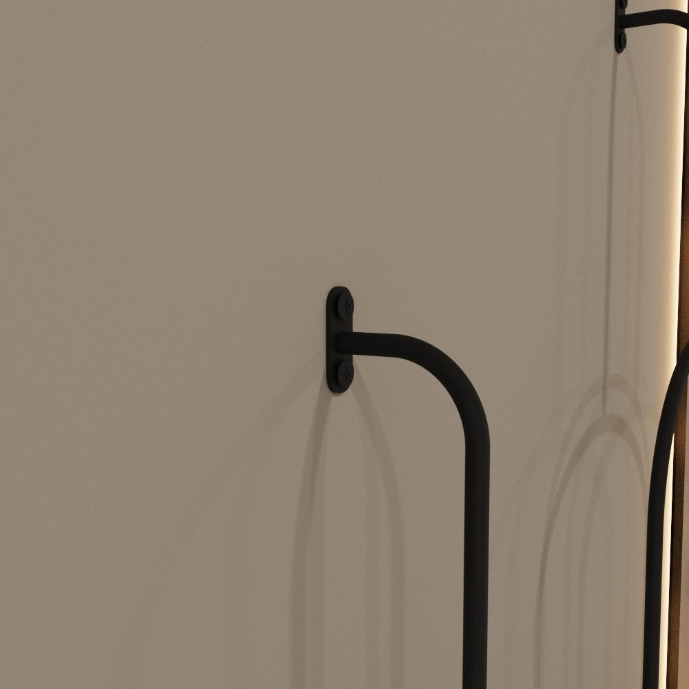 Close-up view of the minimalist towel ring mounted on a wall, showing the attachment details and its sturdy construction.
