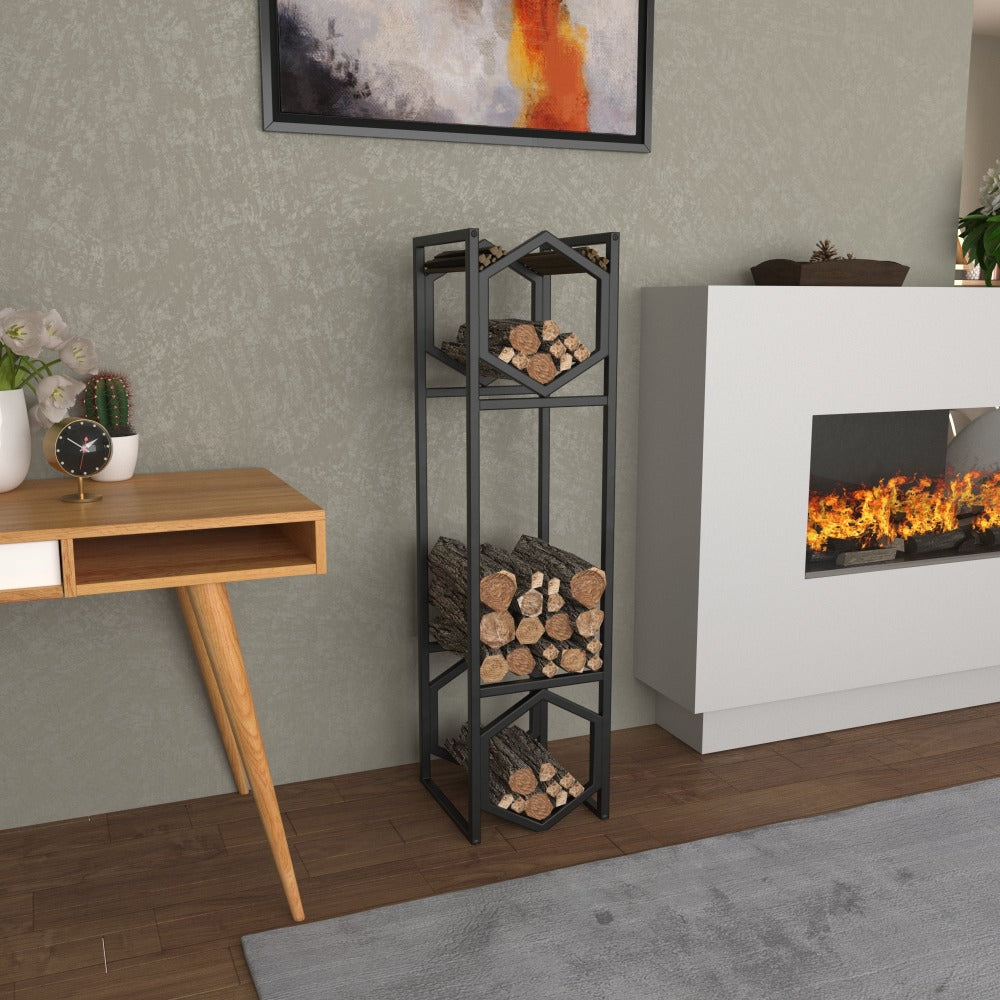 A black modern hexagonal metal log storage rack with three levels, filled with neatly arranged firewood, placed in a stylish living room featuring a wooden desk, decorative plants, and a cozy fireplace.
