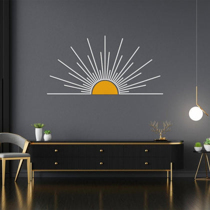 Minimalist metal sunburst wall art featuring a white sunburst design with a yellow center, displayed on a dark wall above a modern black and gold sideboard, creating a bold and stylish statement in a contemporary interior.