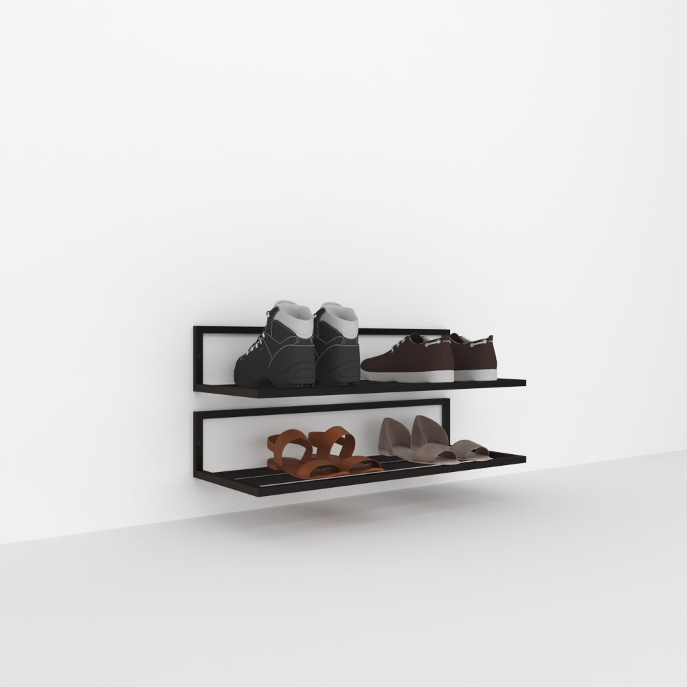 A sleek black wall-mounted shoe rack with two tiers, displaying various footwear including boots, sneakers, and heels, set against a white background for a minimalist look.