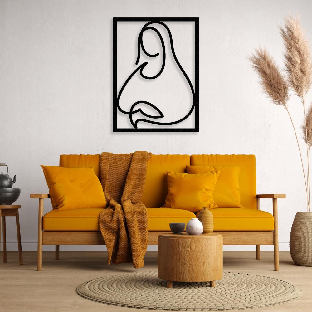 A black minimalist line art metal wall decor inspired by the Mona Lisa, hanging on a white wall above a mustard yellow sofa with matching cushions and decor.