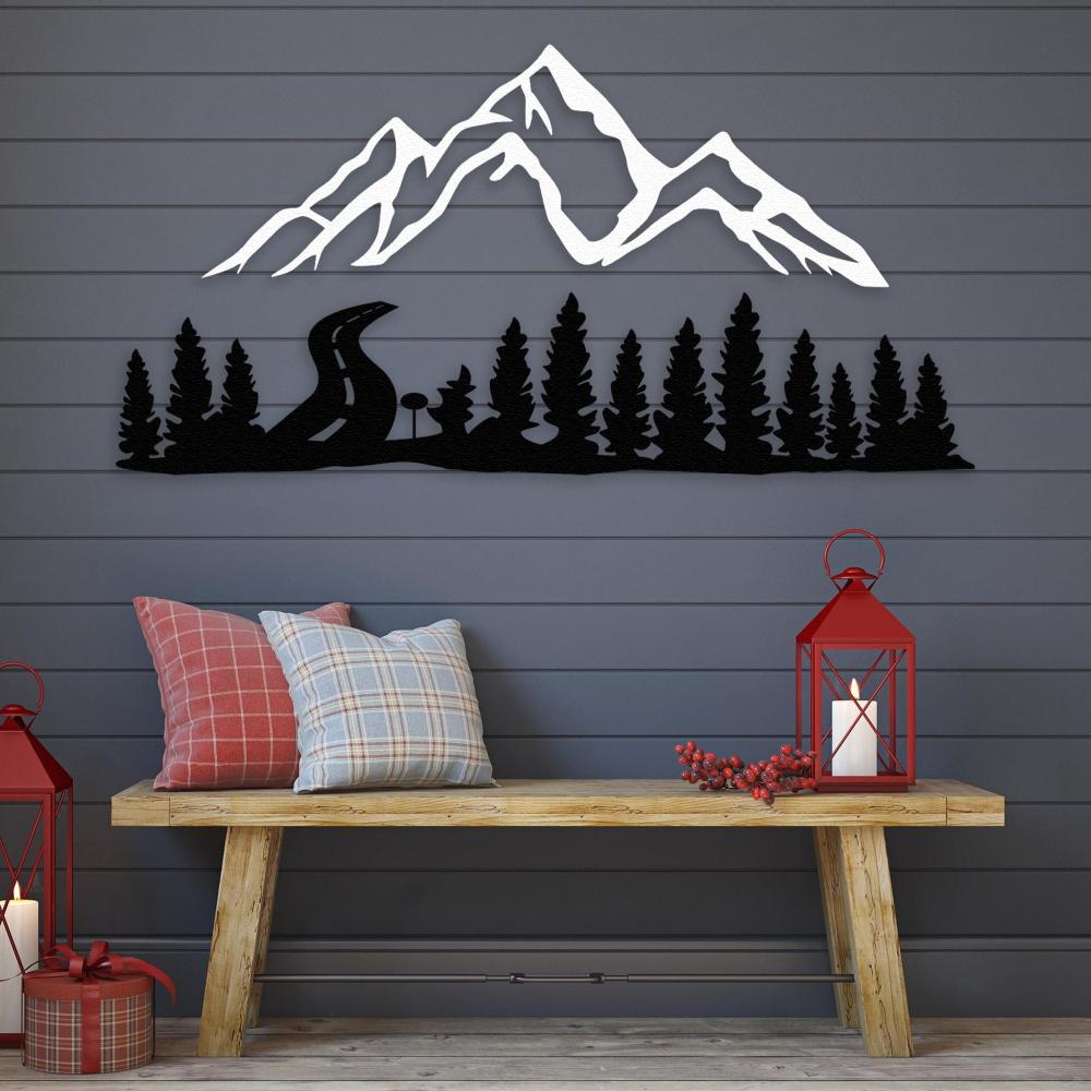 White mountain and black forest-themed metal wall art decor displayed on a dark gray wall, above a rustic wooden bench adorned with plaid cushions and red lanterns, evoking a cozy, holiday-inspired outdoor ambiance.