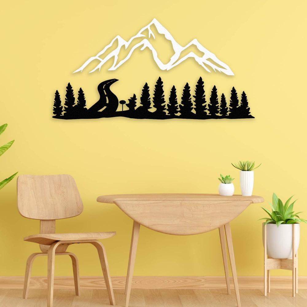Black and white mountain and forest-themed metal wall decor mounted on a vibrant yellow wall, styled above a minimalist wooden table and chair set, complemented by small green potted plants for a fresh, nature-inspired ambiance.