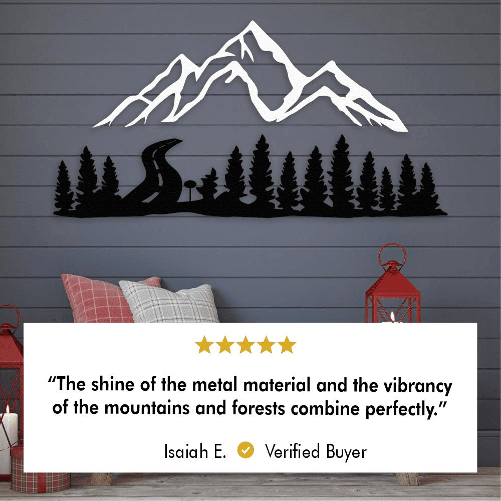 Metal wall art of a mountain scene with trees and a winding road. The mountains are in white, and the trees and road are in black. Below the image is a five-star review from a customer, Isaiah E., stating, "The shine of the metal material and the vibrancy of the mountains and forests combine perfectly." The setting features red lanterns and decorative pillows on a wooden bench.