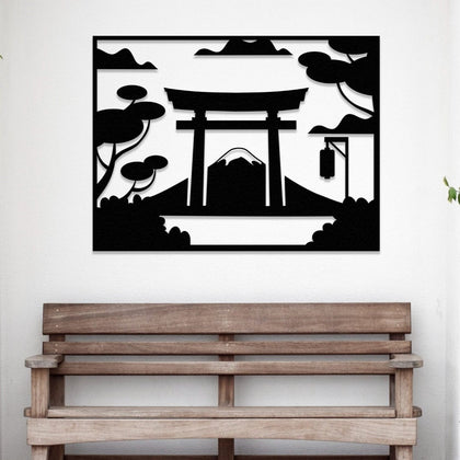 A black metal wall art depicting a Japanese Torii gate with Mount Fuji in the background, placed above a wooden bench in a minimalist entryway.