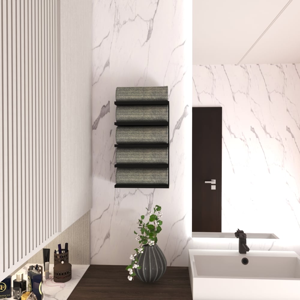 Wall-mounted black towel rack with five tiers, holding rolled green towels, displayed in a modern bathroom with marble walls, a dark wood counter, and decorative elements like a vase with flowers.