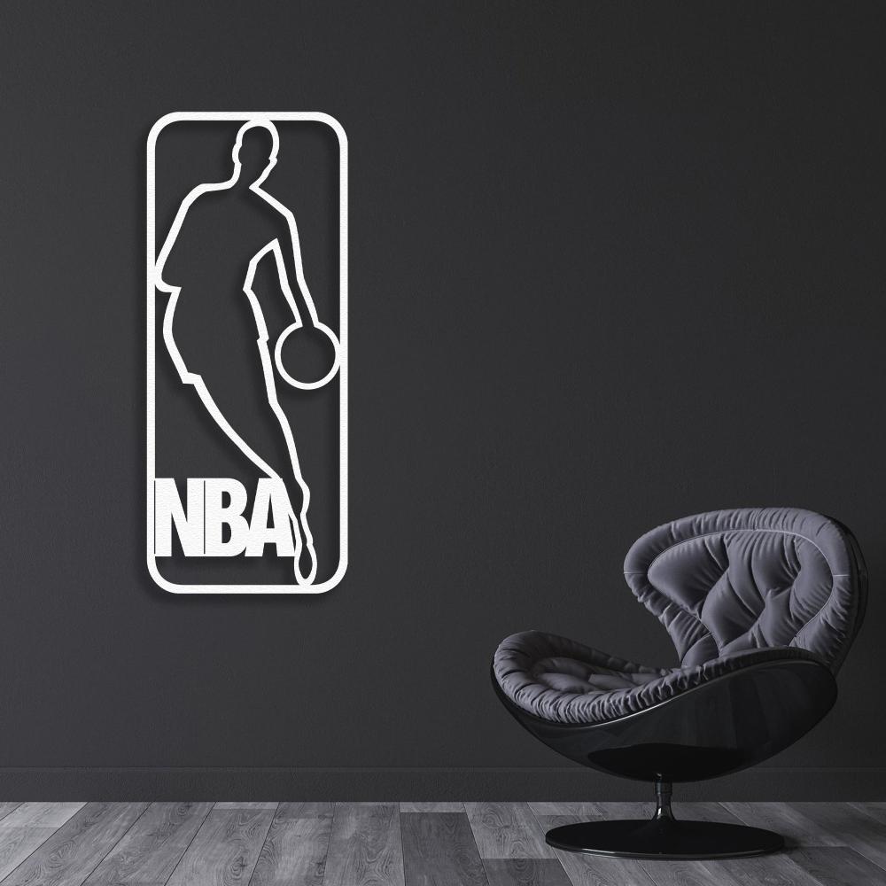 White NBA-themed metal wall art featuring a basketball player silhouette, mounted on a dark wall, paired with a modern black curved accent chair.