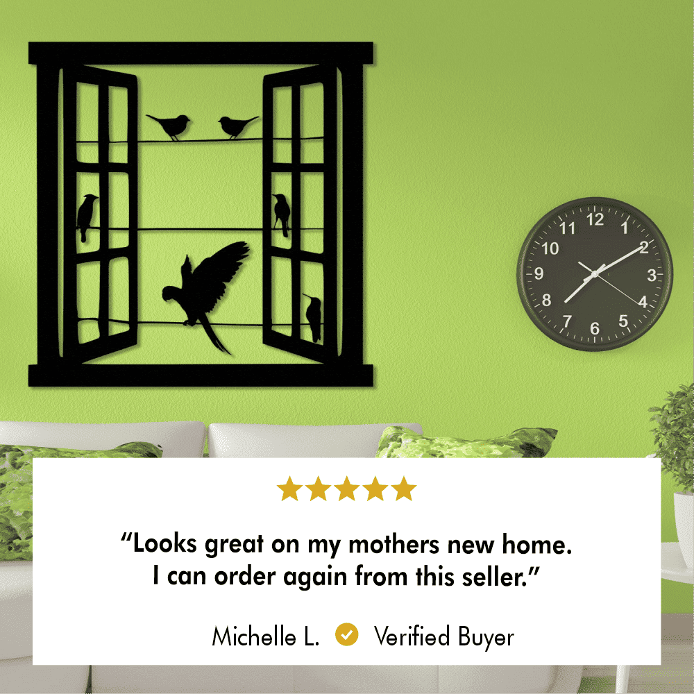Open window metal wall art with perched birds and a flying bird, displayed on a vibrant green wall with a black clock, part of a cozy living room. Includes a review: "Looks great on my mothers new home. I can order again from this seller." by Michelle L., Verified Buyer.