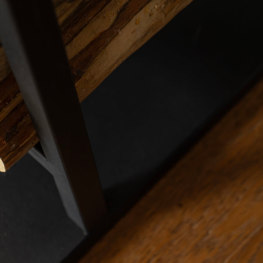Close-up of a wooden shelf with a dark surface