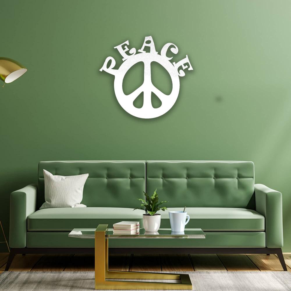 A vibrant living room with a green sofa against a green wall, decorated with a white "Peace" metal wall art. A gold lamp and modern coffee table complete the cozy atmosphere.
