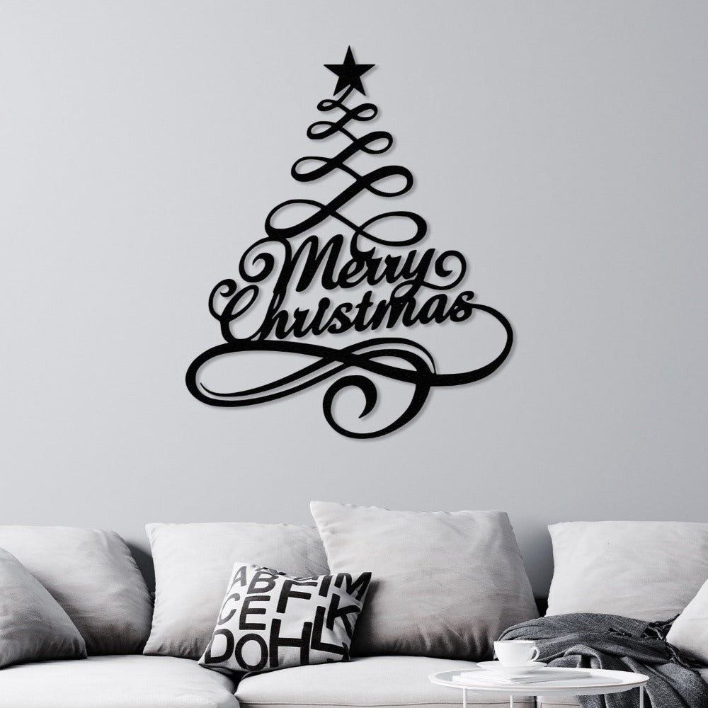 Black metal "Merry Christmas" tree wall art mounted on a light gray wall above a cozy sofa with neutral pillows and a modern coffee table, creating a festive and minimalist living room decor.