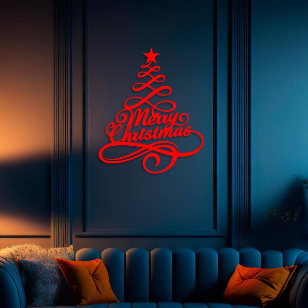 Red metal Christmas tree wall art with "Merry Christmas" script, mounted on a dark blue wall above a cozy sofa with colorful pillows, creating a festive and elegant holiday ambiance.