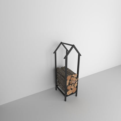 Sleek black Portable Home Shaped Metal Log Storage filled with neatly stacked firewood, placed against a minimalist white wall