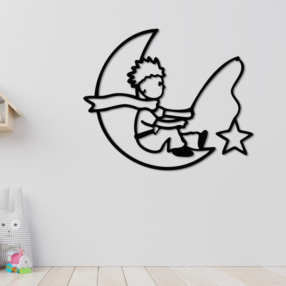 A black metal wall art of a child sitting on a crescent moon with a fishing rod and star, mounted on a white wall in a playful children's space with wooden shelves and minimalistic decor.
