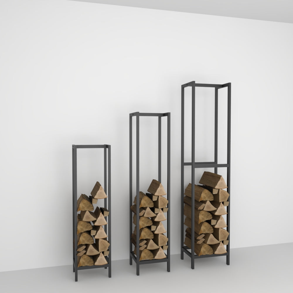 Three black rectangular firewood racks of different sizes, each holding stacked firewood logs, displayed against a plain white wall in a minimalist setting.