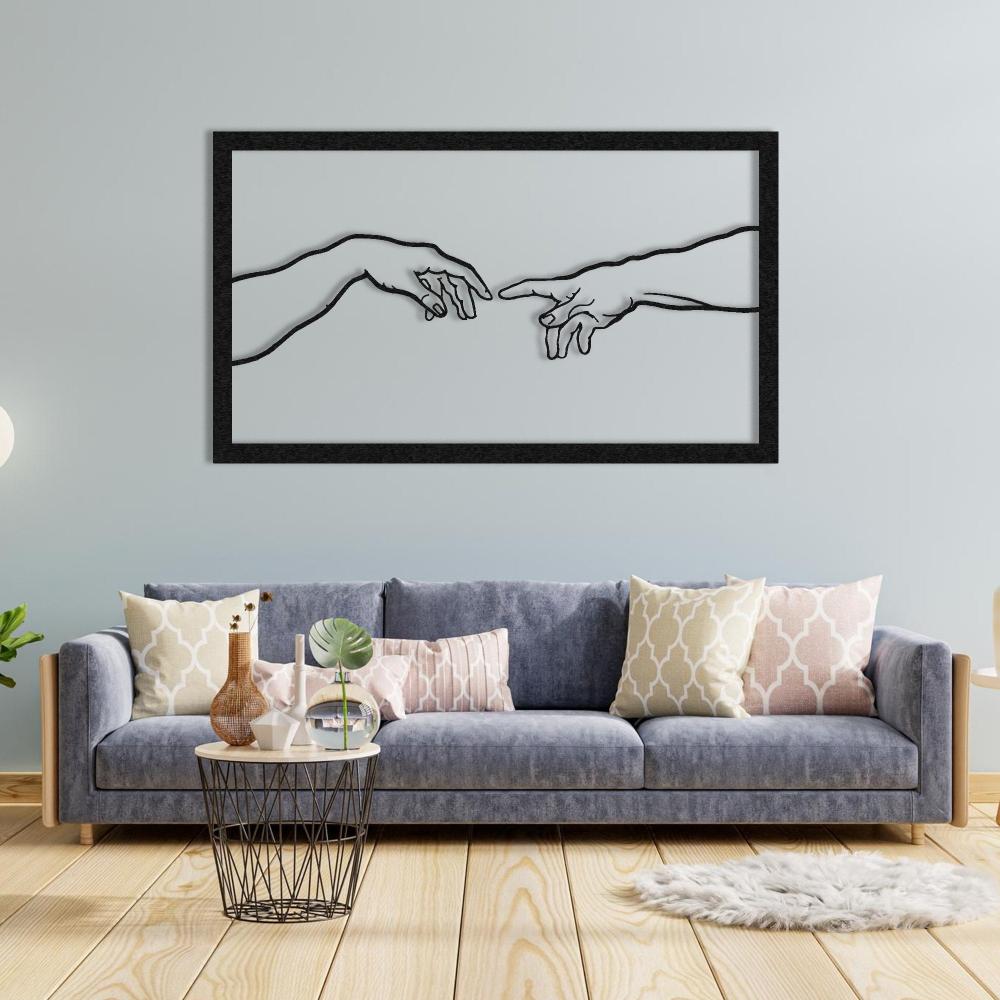 Black metal "Creation of Adam" wall art displayed above a gray sofa adorned with pastel geometric-patterned cushions, a decorative wire-frame coffee table with vases and plants, and a light wooden floor, set against a pale blue wall.