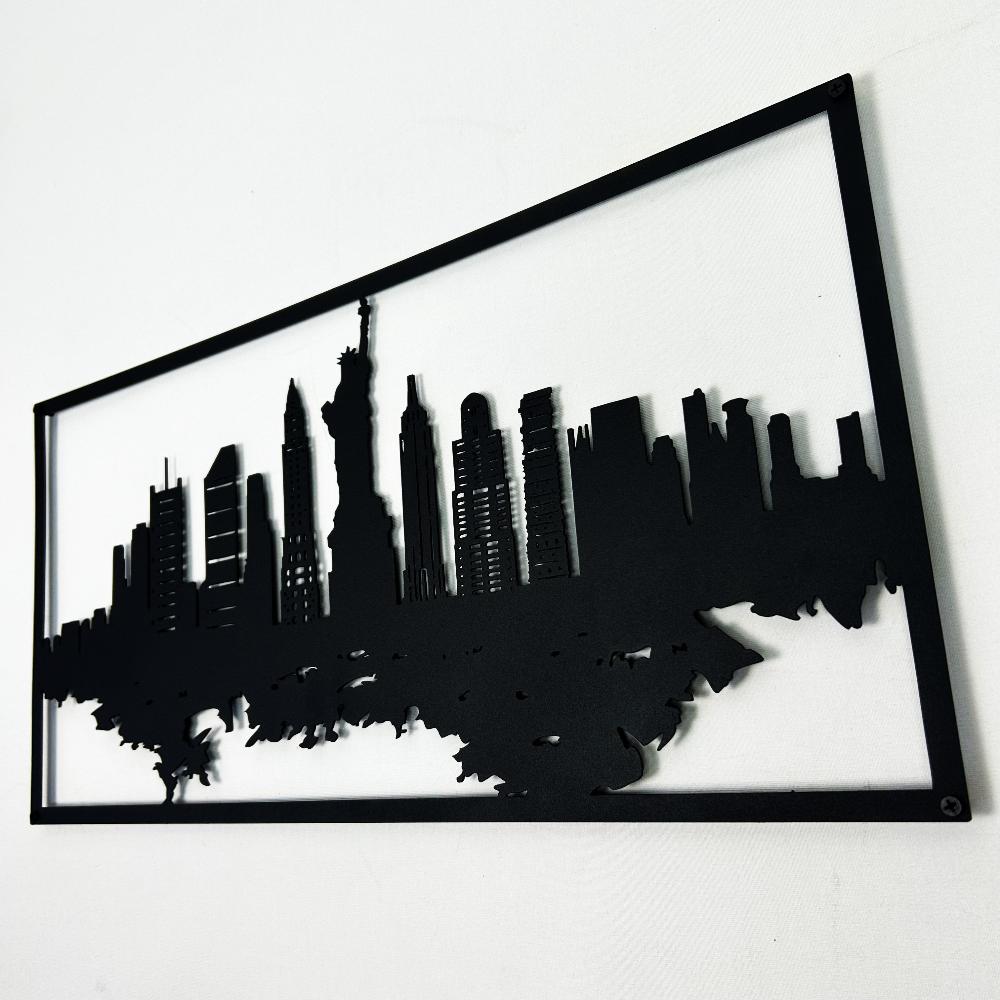 Side angle view of a black New York City skyline metal wall art featuring detailed silhouettes of iconic buildings, including the Statue of Liberty, framed in a rectangular border on a white background.