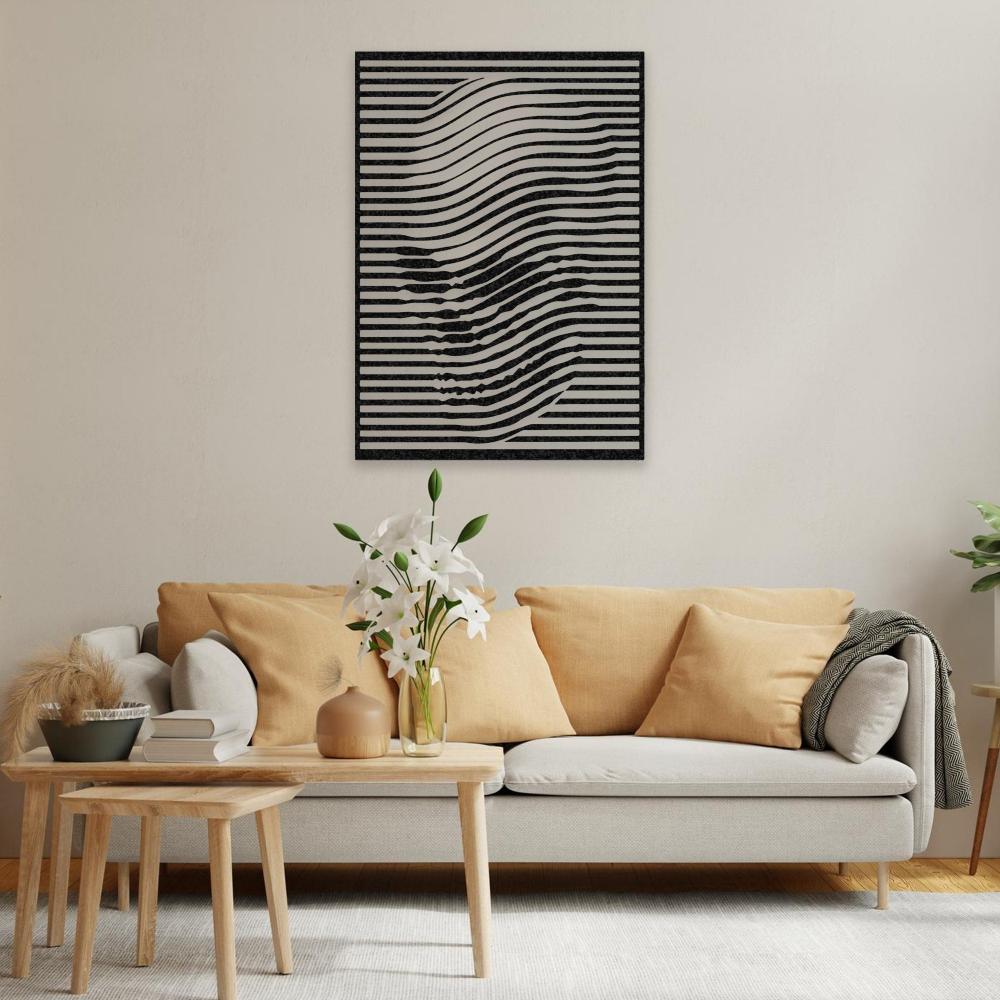 Black skull wall art with wavy line design mounted on a cream-colored wall above a modern beige sofa with mustard-yellow pillows. The room features a wooden coffee table with a vase of white lilies and cozy minimalistic decor.