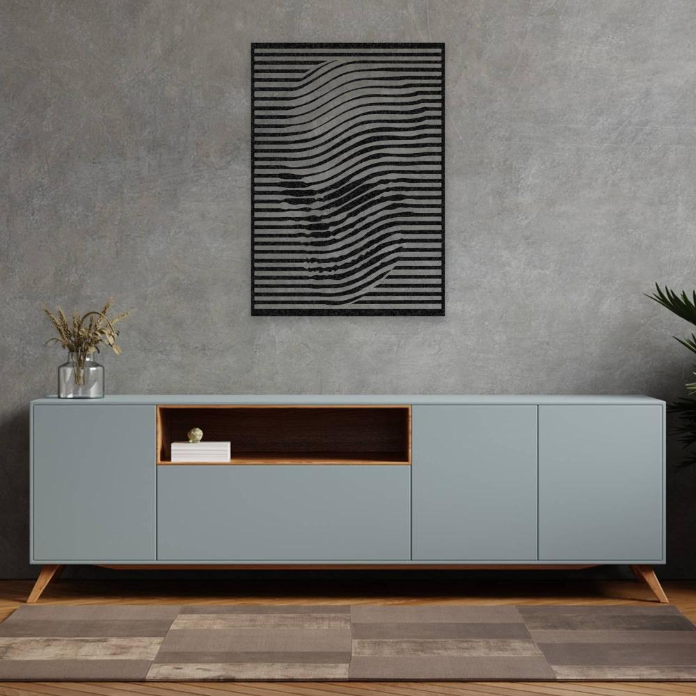 Black skull-themed abstract wall art featuring wavy lines, mounted on a textured gray wall above a modern light blue cabinet with wooden accents. The setting includes a glass vase with dried plants and a minimalistic decor style.