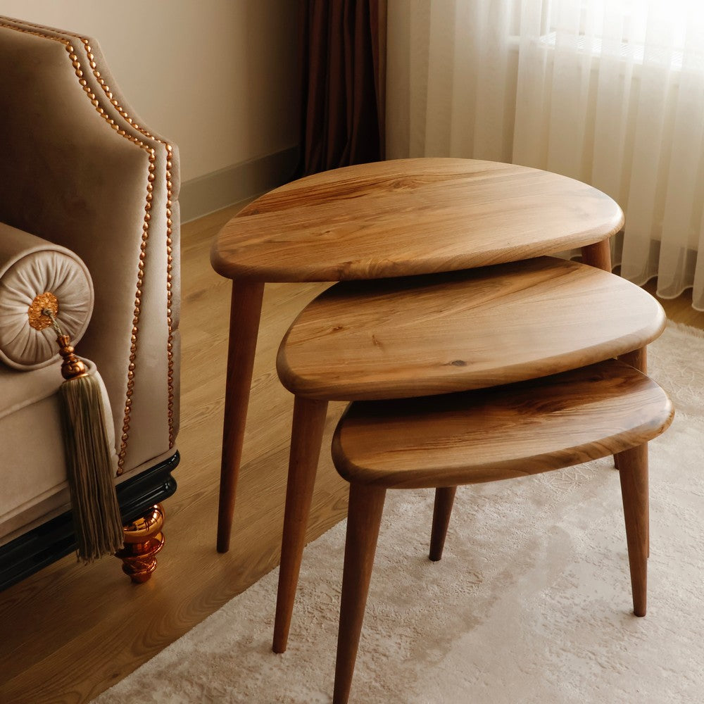 Close-up of stacked oval wooden nesting tables, showcasing smooth wooden grain and craftsmanship.