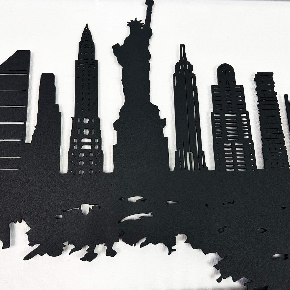 Close-up detailed view of the Statue of Liberty and surrounding skyscrapers in a black New York City skyline metal wall art, highlighting intricate cutouts and clean edges on a white background.