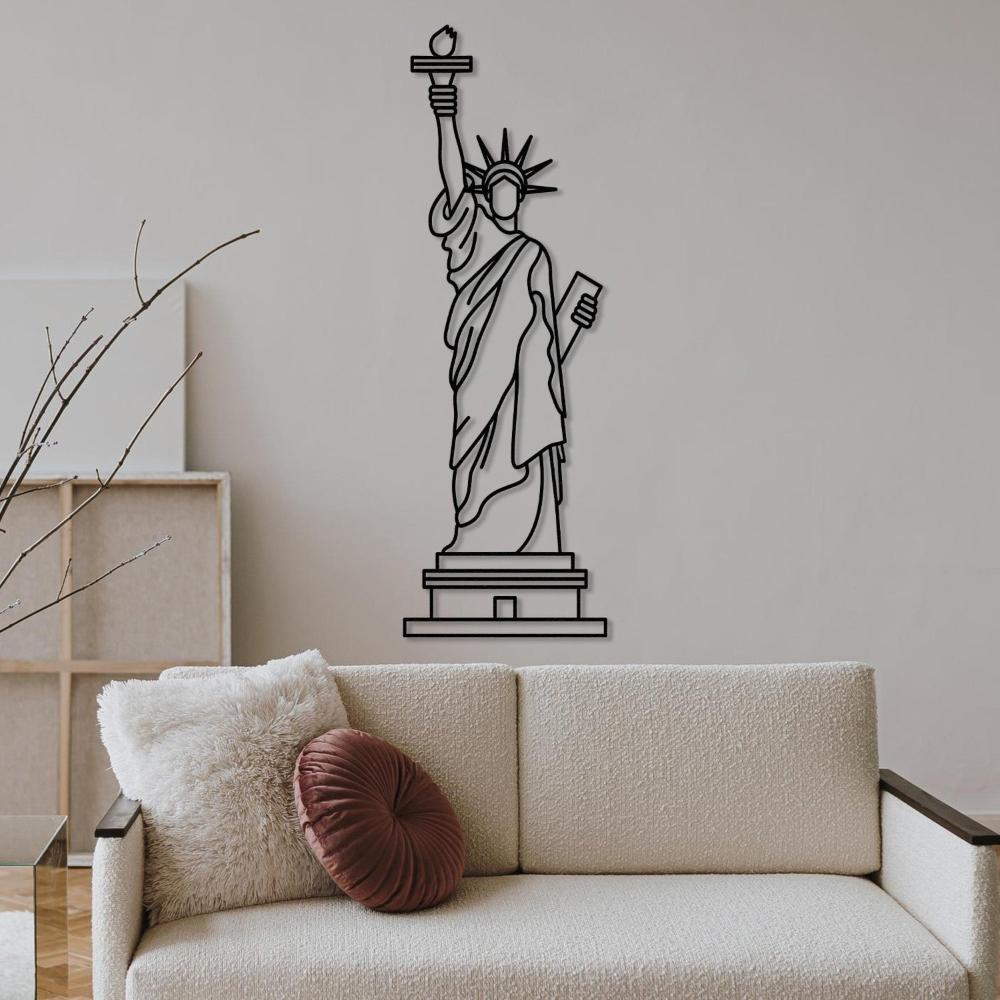 Black line art of the Statue of Liberty wall decor showcased in a cozy living room with a beige couch and a decorative pillow.