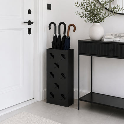 Tall black metal umbrella stand with multi-umbrella pattern beside console table in modern hallway