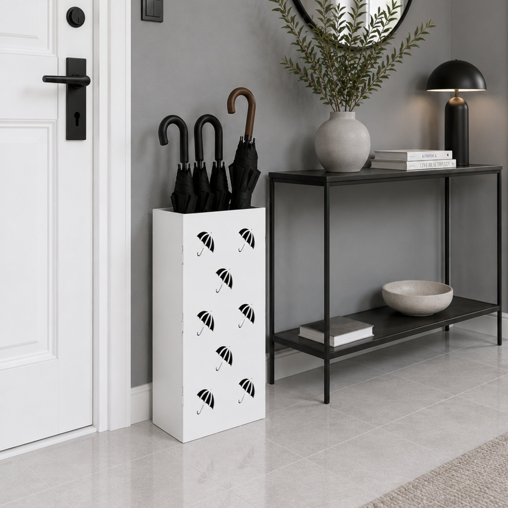 Black metal umbrella stand with multi-umbrella icon pattern detail beside dark console with decor