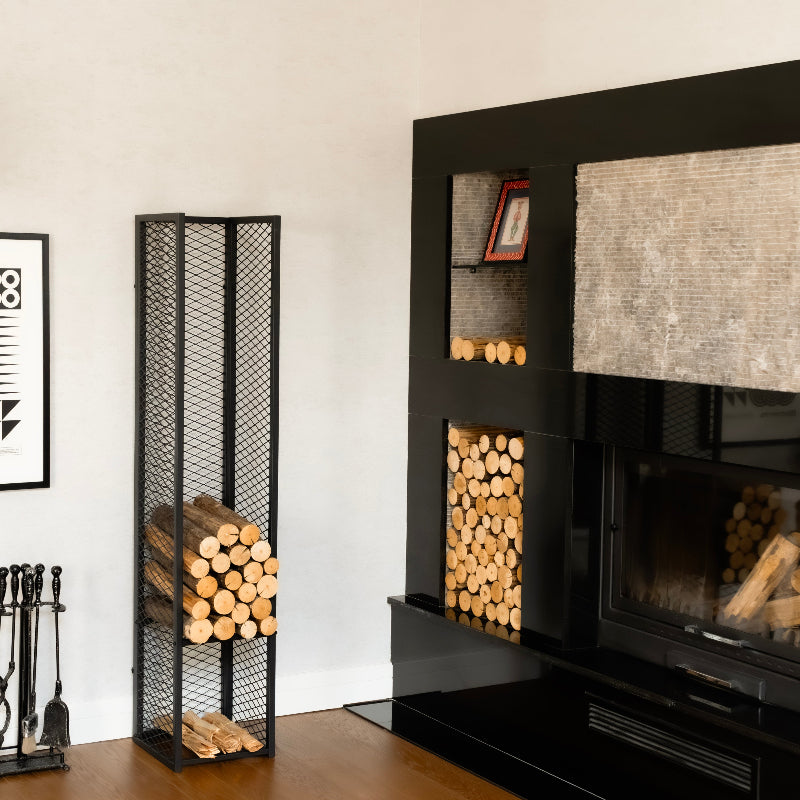 Modern fireplace with wood storage and decorative elements in a room.