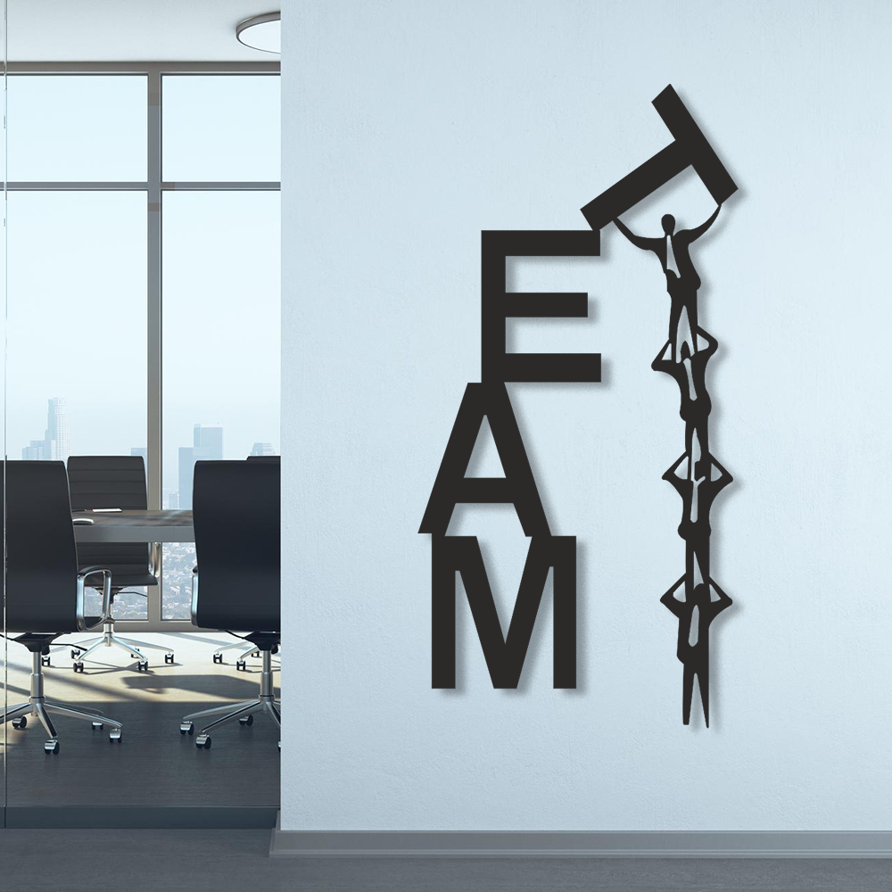 Decorative wall art with 'TEAM' letters and a person climbing on a mountain in an office setting.