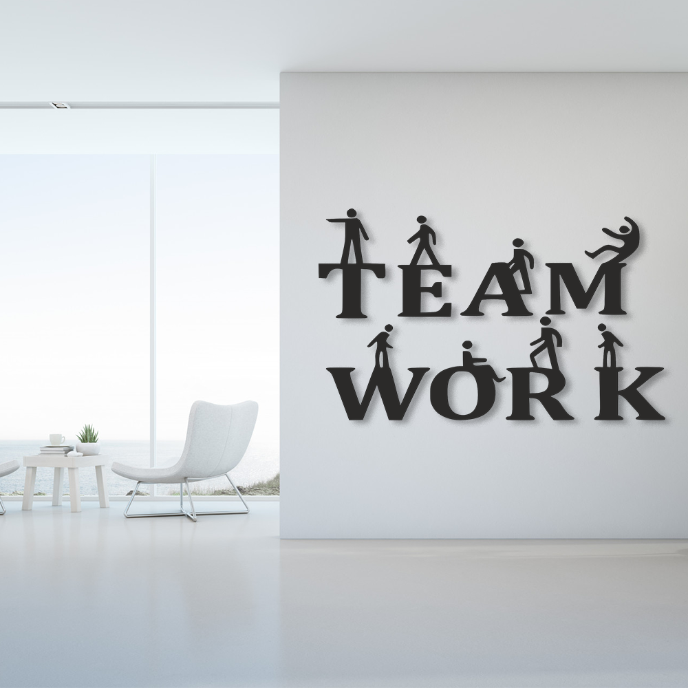 Decorative wall art with 'TEAM WORK' and silhouettes of people in a modern office setting.